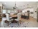 Bright dining area with a round table, upholstered chairs, and an open view into the kitchen and living room at 3628 Silvery Way, Powder Springs, GA 30127