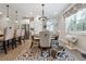 Charming dining area with a modern chandelier and views of the backyard at 3628 Silvery Way, Powder Springs, GA 30127