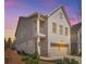 Charming two-story home with white brick and gray siding, complemented by a well-manicured front yard and a two-car garage at 3628 Silvery Way, Powder Springs, GA 30127