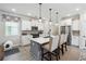Bright kitchen featuring white cabinets, stainless steel appliances, an island with seating, and modern pendant lighting at 3628 Silvery Way, Powder Springs, GA 30127