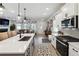 Open-concept kitchen with stainless steel appliances, a large island, and a seamless transition to the living room at 3628 Silvery Way, Powder Springs, GA 30127
