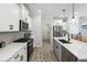 Modern kitchen with stainless steel appliances, white cabinets, and a stylish backsplash at 3628 Silvery Way, Powder Springs, GA 30127