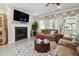 Relax in this inviting living room featuring a fireplace, large windows, and stylish decor at 3628 Silvery Way, Powder Springs, GA 30127