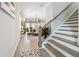 Open-concept living space featuring a staircase and a view into the dining area and living room at 3628 Silvery Way, Powder Springs, GA 30127
