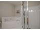 Bright bathroom offering a soaking tub, a glass-enclosed shower, and tile flooring at 375 Highland Ne Ave # 903, Atlanta, GA 30312