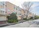 Street view of attractive townhomes with brick driveways and attached garages at 375 Highland Ne Ave # 903, Atlanta, GA 30312