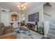 Open-concept living room with view into kitchen, breakfast bar, stairs and modern decor at 375 Highland Ne Ave # 903, Atlanta, GA 30312