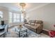 Cozy living room with a leather sofa, area rug, bay windows, and natural light at 375 Highland Ne Ave # 903, Atlanta, GA 30312
