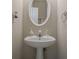 Stylish powder room featuring a pedestal sink, framed mirror, and neutral wall paint at 375 Highland Ne Ave # 903, Atlanta, GA 30312