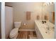Bright bathroom features wood-look flooring, white vanity, and a framed mirror with vanity lighting at 5364 Hickory Knl, Norcross, GA 30071