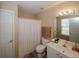 This bathroom features wood-look floors, a white vanity, and a shower with a curtain at 5364 Hickory Knl, Norcross, GA 30071