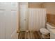 Bathroom view showcasing wood-look flooring, toilet, and a shower with a curtain at 5364 Hickory Knl, Norcross, GA 30071