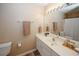 Bathroom with a white vanity, mirror with decorative light bar and a shower/tub with curtain at 5364 Hickory Knl, Norcross, GA 30071