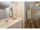 Bathroom view shows a white vanity and mirror, wood-look floors, and access to a bedroom at 5364 Hickory Knl, Norcross, GA 30071