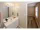 This bathroom features wood-look floors, a white vanity and access to another room at 5364 Hickory Knl, Norcross, GA 30071