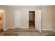 Bedroom showing the neutral color scheme, hardwood floors, and an open door to the bath and hall at 5364 Hickory Knl, Norcross, GA 30071