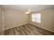 Bedroom showing wood flooring, a ceiling fan, and a window for natural lighting at 5364 Hickory Knl, Norcross, GA 30071