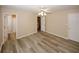 Bedroom featuring neutral walls, vinyl flooring, and multiple door ways to other rooms at 5364 Hickory Knl, Norcross, GA 30071