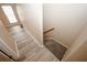 Hallway with wood-look floors leading to carpeted stairs and a bright window at 5364 Hickory Knl, Norcross, GA 30071
