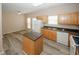 Neutral kitchen with an island, white appliances, and a window at 5364 Hickory Knl, Norcross, GA 30071