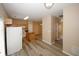 Bright kitchen features gray wood-look floors, island, and white appliances at 5364 Hickory Knl, Norcross, GA 30071