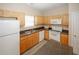 Galley-style kitchen featuring wooden cabinets and white appliances at 5364 Hickory Knl, Norcross, GA 30071