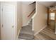 A staircase with carpeted steps, wood railing, and a neutrally painted wall at 5364 Hickory Knl, Norcross, GA 30071