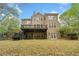 Backyard view showing deck, patio, and exterior of home with large windows at 940 Magnolia Blossom Ct, Alpharetta, GA 30005