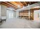 Unfinished basement with exposed ceiling, shelving, workbench, and double doors at 940 Magnolia Blossom Ct, Alpharetta, GA 30005