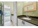 Bathroom with custom mirror and vanity with stone countertop at 940 Magnolia Blossom Ct, Alpharetta, GA 30005