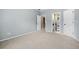 Spacious bedroom with neutral decor and multiple doors at 940 Magnolia Blossom Ct, Alpharetta, GA 30005