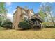 Multi-story home showcasing an expansive deck and mature landscaping, creating a private outdoor living space at 940 Magnolia Blossom Ct, Alpharetta, GA 30005