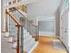 Open foyer features hardwood floors, carpeted stairs, and large entry door at 940 Magnolia Blossom Ct, Alpharetta, GA 30005
