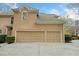 Attached two-car garage with paved driveway and neutral exterior at 940 Magnolia Blossom Ct, Alpharetta, GA 30005