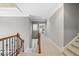 Upstairs hallway with hardwood railing and carpeted floors at 940 Magnolia Blossom Ct, Alpharetta, GA 30005