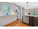 Well-appointed kitchen features stone countertops, custom cabinetry, stainless steel appliances, and modern lighting fixtures at 940 Magnolia Blossom Ct, Alpharetta, GA 30005