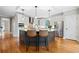 Bright kitchen featuring stainless steel appliances, an eat-in island, modern lighting, and hardwood floors at 940 Magnolia Blossom Ct, Alpharetta, GA 30005