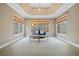 Spacious main bedroom featuring tray ceiling, sitting area, and multiple windows at 940 Magnolia Blossom Ct, Alpharetta, GA 30005