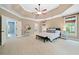 Spacious main bedroom with tray ceiling, ensuite bathroom, and lots of natural light at 940 Magnolia Blossom Ct, Alpharetta, GA 30005
