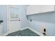 Practical mud room features tile floor, storage cabinets, and convenient access to the outdoors at 940 Magnolia Blossom Ct, Alpharetta, GA 30005