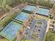 Aerial view of the community tennis courts and parking lot, offering ample space for residents at 940 Magnolia Blossom Ct, Alpharetta, GA 30005