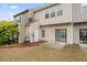 Exterior of townhouse featuring siding, sliding glass doors, and a small patio area at 1730 Stanwood Nw Dr, Kennesaw, GA 30152
