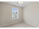 Cozy bedroom with natural light from the window and a ceiling fan at 1730 Stanwood Nw Dr, Kennesaw, GA 30152