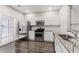 Bright kitchen featuring white cabinets, stainless steel appliances, and granite counters at 1730 Stanwood Nw Dr, Kennesaw, GA 30152