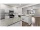 Modern kitchen featuring granite countertops, stainless appliances, and white cabinets at 1730 Stanwood Nw Dr, Kennesaw, GA 30152