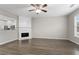 Open-concept living room with a fireplace and wood flooring at 1730 Stanwood Nw Dr, Kennesaw, GA 30152