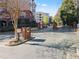Gated community entrance with brick features and mature trees providing an added layer of security at 4333 Dunwoody Park # 1211, Atlanta, GA 30338
