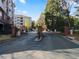 Community entrance with gated entry, set within a lush, green landscape at 4333 Dunwoody Park # 1211, Atlanta, GA 30338