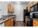 Well-equipped kitchen featuring wood cabinets, granite countertops, and hardwood floors at 4333 Dunwoody Park # 1211, Atlanta, GA 30338