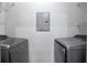 Appealing laundry room showcasing modern washer and dryer units with overhead shelving at 4333 Dunwoody Park # 1211, Atlanta, GA 30338
